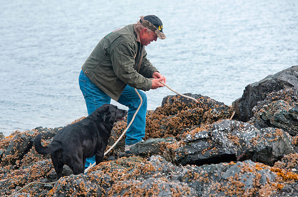 Big Al and his dog ties up the boat,