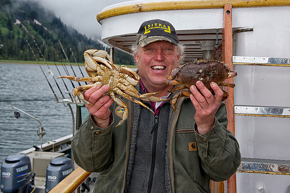 Big Al holds up two fresh crabs