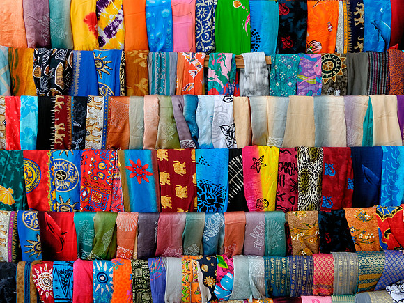 Silk scarves sit on a rack