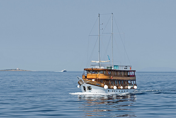 Cruising boat passes MS Mendula