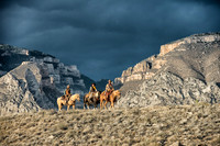 Three Riders high on the ridge against a stormy background