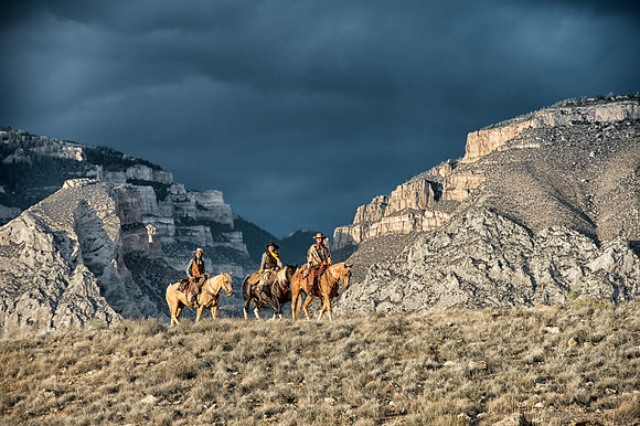 Three Riders high on the ridge against a stormy background
