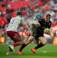 Jamie Roberts (12) of Harlequins tackles a Saracens player