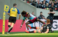 Maryland Yarde of Harlequins tackles a Saracens player