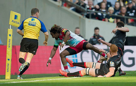 Maryland Yarde of Harlequins tackles a Saracens player