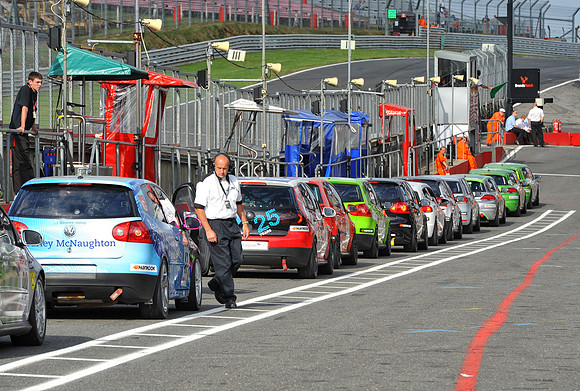 A marshall checks the cars in the APR Volkswagen Racing Cup