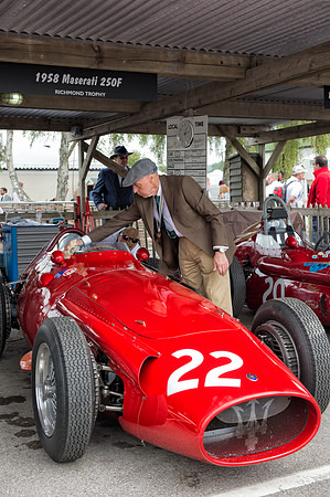 Allan Miles polishing the Maserati 250F in the paddock